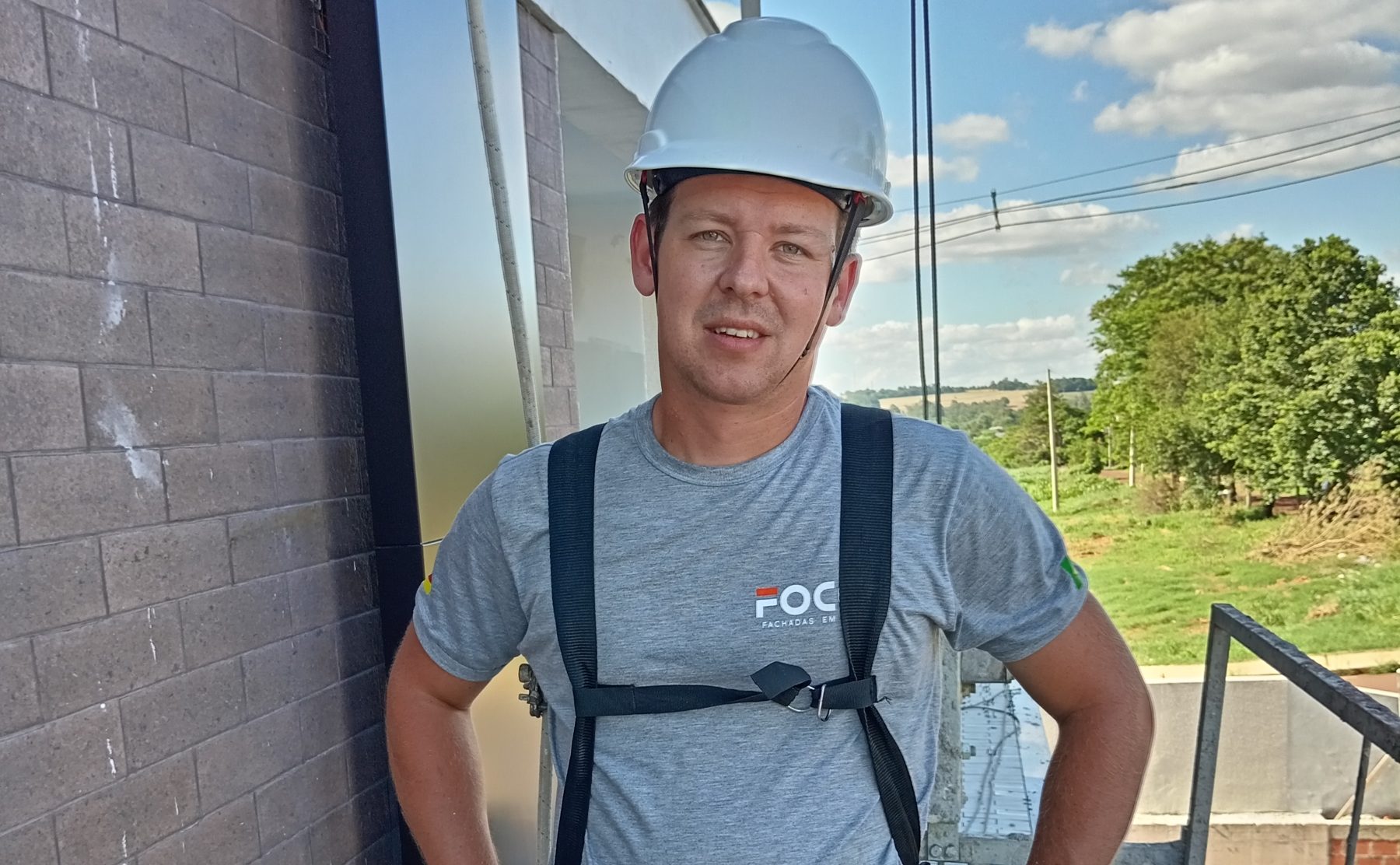 An installer in a harness on site, before work starts